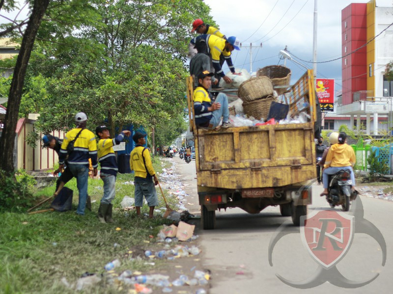 Petugas kebersihan singkawang berjibaku membersihkan hamparan sampah di kawasan persimpangan Kantor Imigrasi Singkawang, Minggu (5/2). (Foto: Topan/RN)